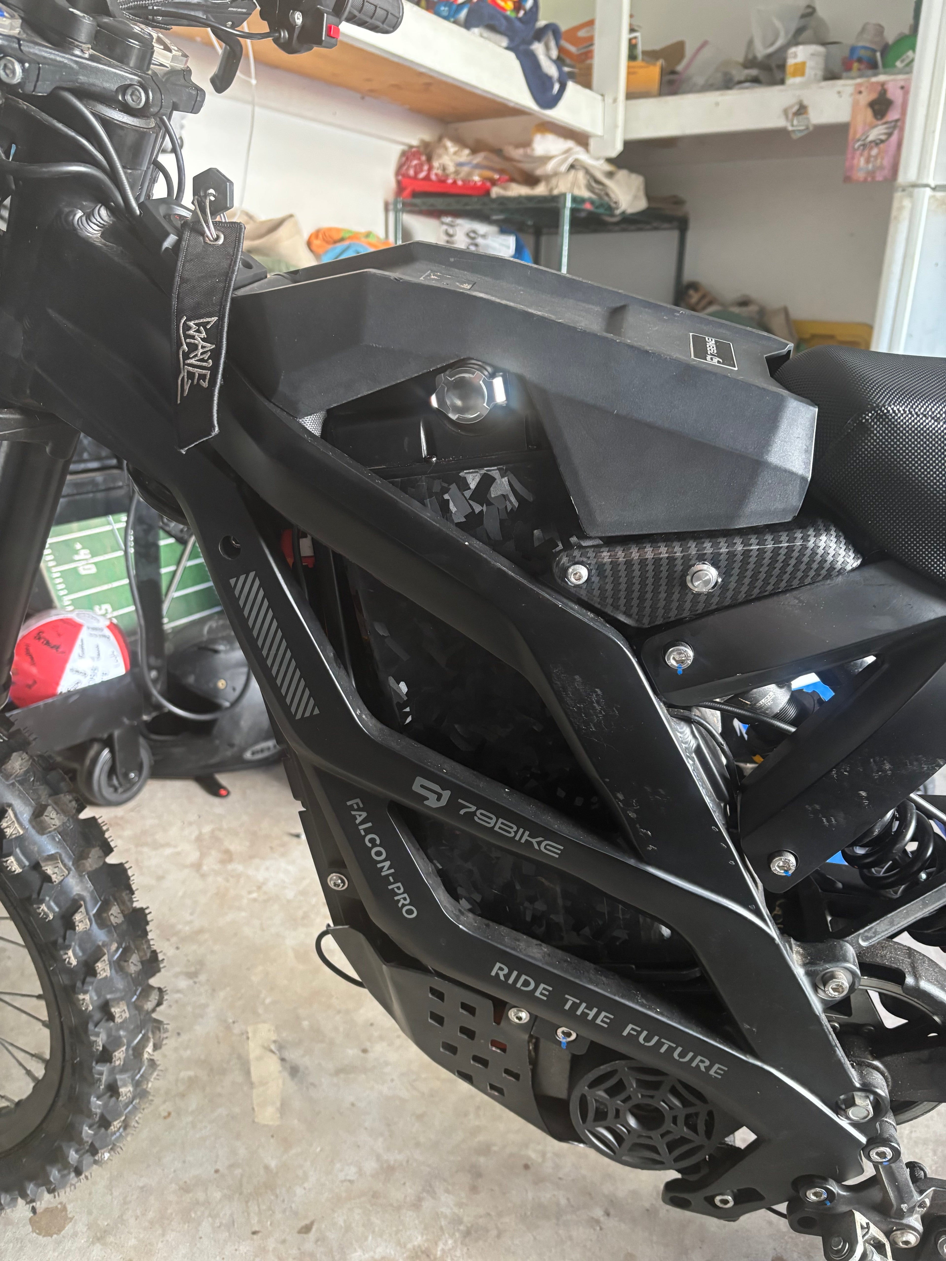 Forged carbon fiber battery wrap installed on a Sur-Ron battery cover