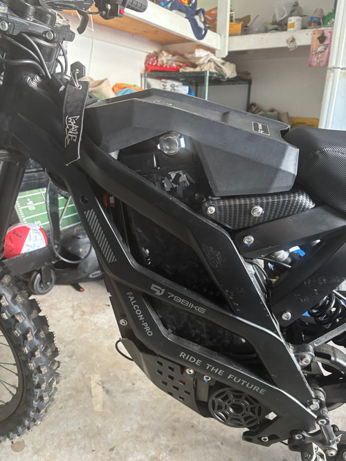 Forged carbon fiber battery wrap installed on a Sur-Ron battery cover